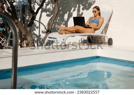 Poolside Professional: Young Woman Balancing Work and Leisure