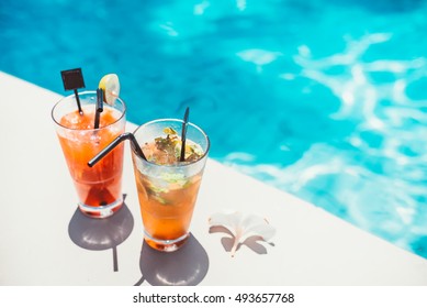 poolside symmetric cocktails served cold at pool bar with mojito and gin and tonic lemonade