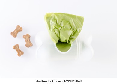 poop bags with dog treats on white background
