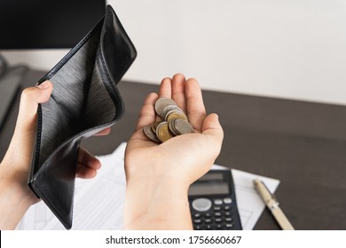 Poor Asian Man Hand Open Empty Wallet And Holding Coins Looking For Money Having Problem Bankrupt Broke After Credit Card Payday. Insolvency In The Economy And Finance. People Have No Money.