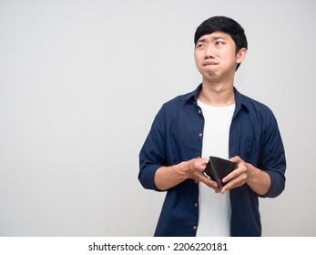 Poor Asian Man Holding Empty Wallet Feels Sad Looking At Copy Space