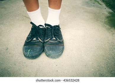 Poor Asian Student Going Back To School Wears Old Worn Black Leather Shoes. Vintage Tone 