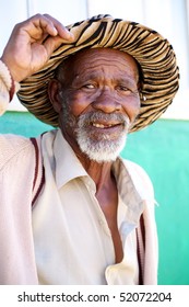 Poor Black South African Man Holding His Hat With A Friendly Expression On His Face.