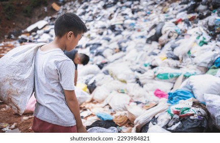 Poor boy collecting garbage in his sack to earn his livelihood, The concept of poor children and poverty