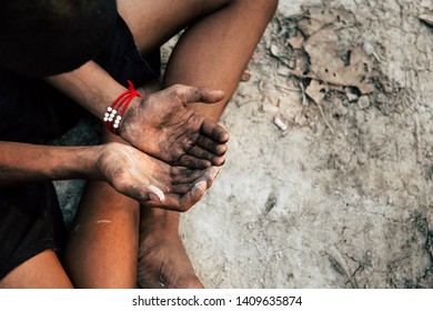 poor child or beggar begging you for help sitting at dirty slum. concept for poverty or hunger people,human rights,donate and charity for underprivileged children in third world - Shutterstock ID 1409635874