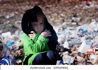 Poor Child Freezes Sitting In A Garbage Dump