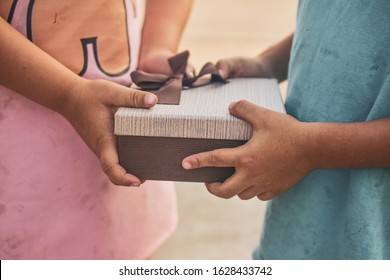 Poor Children Are Accepting Gifts,Girl Giving Gift Box To Boy