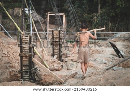 Poor children at the construction site were forced to work. Concept against child labor. The oppression or intimidation of forced labor among children. Human trafficking.