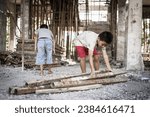 Poor children forced to do construction work, child labor, abuse To the rights of children, victims of human trafficking, World Day Against Child Labor.