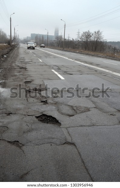 Poor condition of
the road surface. Winter season. Hole in the asphalt, risk of
movement by car, bad asphalt, dangerous road, potholes in asphalt.
February 4, 2019.
Kiev,Ukraine