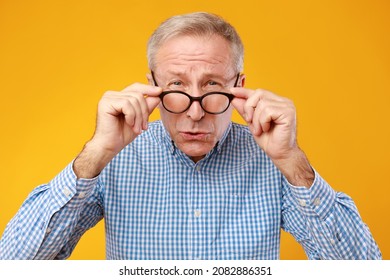 Poor Eyesight. Senior Man Can't See, Squinting Eyes Wearing Eyeglasses Having Problems With Vision, Looking At Camera, Yellow Orange Wall. Ophtalmic Issue In Older Age, Macular Degeneration Concept - Powered by Shutterstock