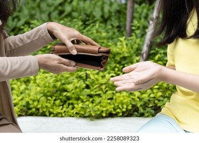 Poor family of single mother and teen daughter having no money, struggling with economic crisis, unemployment, inflation with empty purse - Shutterstock ID 2258089323
