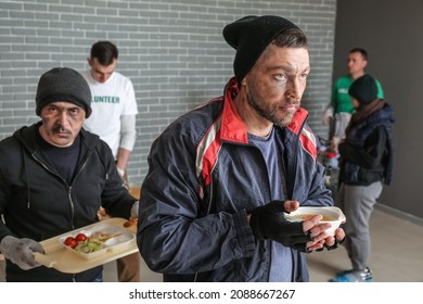 Poor Homeless Man With Hot Food In Warming Center