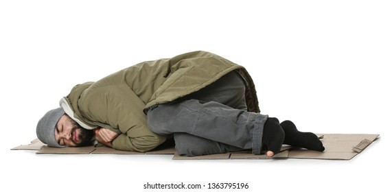Poor homeless man lying on cardboard, white background