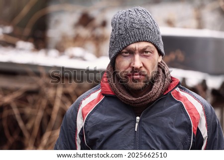 Poor homeless man outdoors on winter day