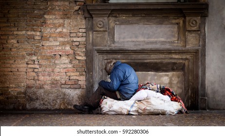 Poor Homeless Man In The Street With His Bags