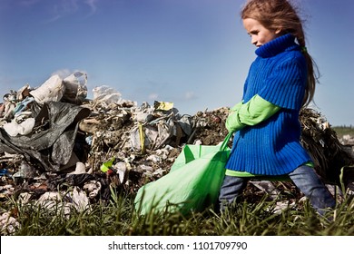 A Poor Hungry Child Is Dragging A Heavy Bag In A Garbage Dump