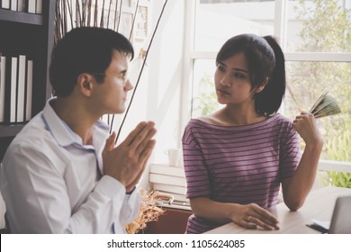 Poor Husband Begging His Wife For Money. Married Couple Having A Fight Over Income. For Family Financial Problem Concept.