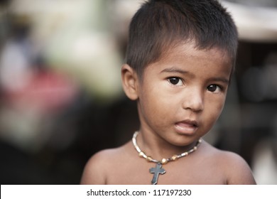 Poor Indian child in outdoor background.