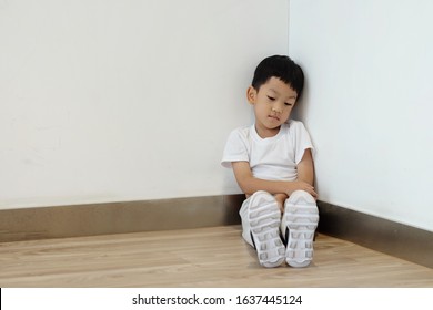 Poor Kid Upset And Sit At Corner And Try Control Emotions. Child In Trouble. A Young Boy Being Disciplined. Concept Punish Kid And Time Out Limit, Rule And Punishment, Problem And Handle, Terrible Two