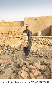 A Poor Laborer Working Hard In Extreme Heat On A Construction Site