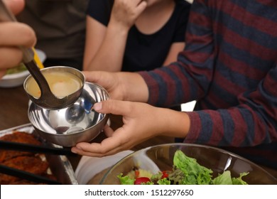 Poor Little Children Receiving Food From Volunteer In Charity Centre, Closeup