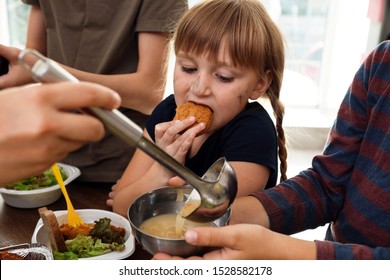 Poor Little Children Receiving Food From Volunteer In Charity Centre