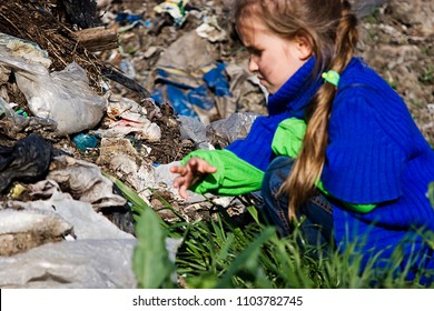 Poor Little Girl Digs At The Garbage Dump