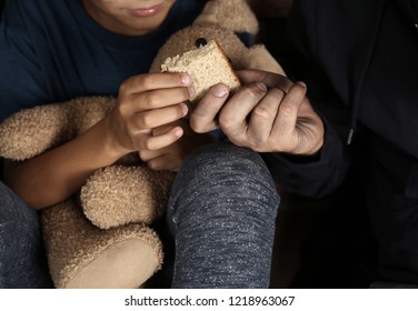 Poor Man Giving Piece Of Bread To His Son, Focus On Hands