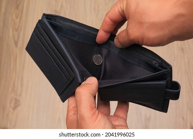 Poor Man Hand Open Wallet With One-shekel Coin Looking For Money, Broke, Bankrupt Concept.