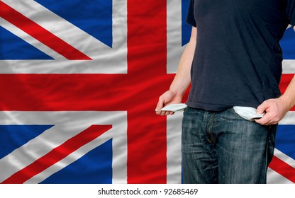 Poor Man Showing Empty Pockets In Front Of Uk Flag