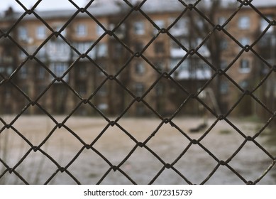 Poor Neighborhood Area Behind Grid Fence