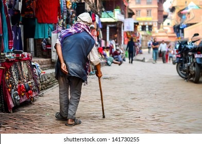 Poor Old Man Walking With Stick In Exotic Asian Street, Nepal