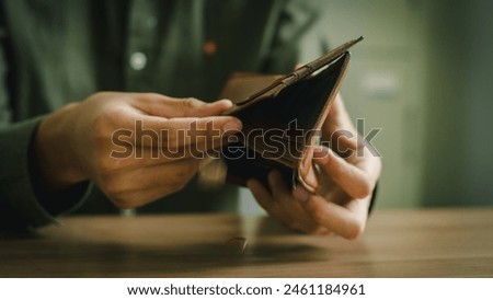 Poor people go bankrupt, empty wallet (no money) in the hands of a man Bankruptcy due to economic downturn, no credit, no emergency savings, crisis,  High cost of living in city concept.