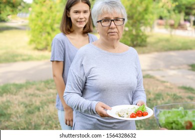 Poor People Receiving Food From Volunteers