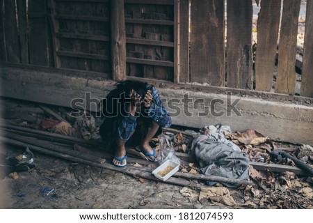 poor people,homeless or beggar begging for help sitting at dirty slum.concept for poverty hunger,human rights,donate and charity for underprivileged children in third world