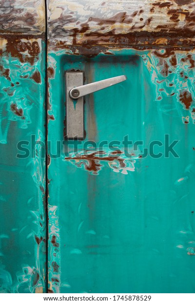 Poor\
quality paint on the car, cracks and scratches on the rusty metal\
surface. Abstract pattern, texture, pattern detail background with\
rusty stains. A car door handle on an old green\
car