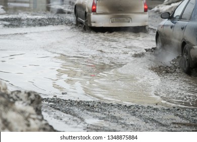 Poor road condotions - car wheel in melting show puddle. - Shutterstock ID 1348875884