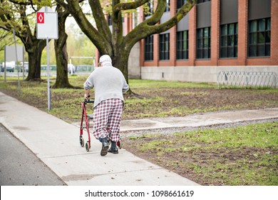 Poor senior men walking with a walker outside
