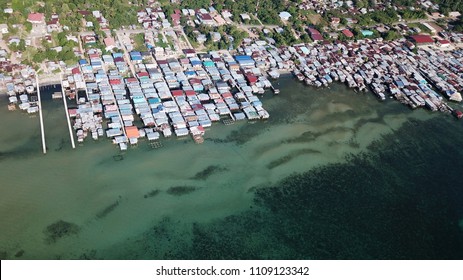 Poor slum in Asia. Villages like this are at risk from climate change and rising sea levels - Shutterstock ID 1109123342