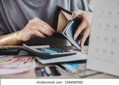 poor woman hand open empty purse looking for money for credit card debt, bankrupt concept