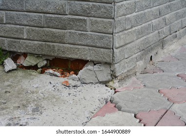 Poorly constructed foundation of the house. Ashlar facade bricks are broken damaging the foundation.