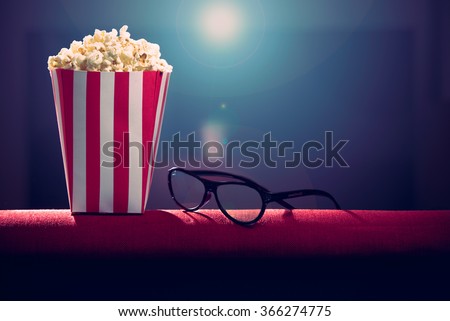 pop corn and 3d glasses on armchair cinema