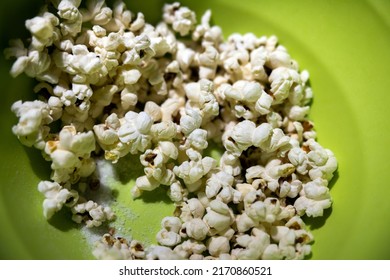 Pop Corn With Too Much Salt In A Green Bowl Close Up