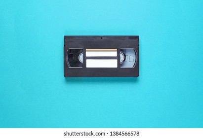 Pop Culture Retro Attributes 80s, Video Cassette On Blue Background. Top View