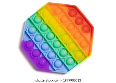 Pop It silicone sensory anti-stress Fidget kid toy colorful rainbow game isolated on white background, copy text space. Calming tools, adult stress reliever popping, trendy push bubble toys
