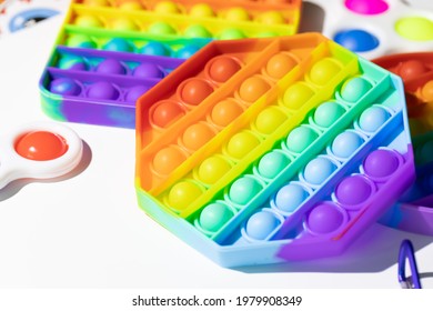 Pop It Simple Dimple - silicone sensory anti-stress Fidget toy colorful rainbow game isolated on white background, copy space. Calming tools, adult stress reliever popping, trendy push bubble toys - Shutterstock ID 1979908349