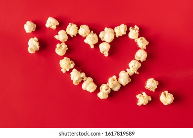 popcorn blast heart shape with corn on red  isolated  