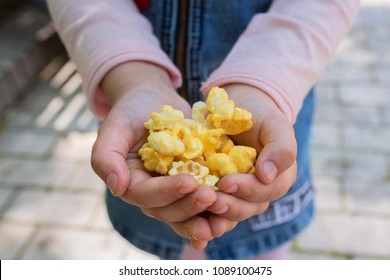 Popcorn in children's hands close up.