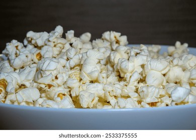 popcorn close up. popcorn with selective focus. popcorn, corn grains on a wooden table - Powered by Shutterstock